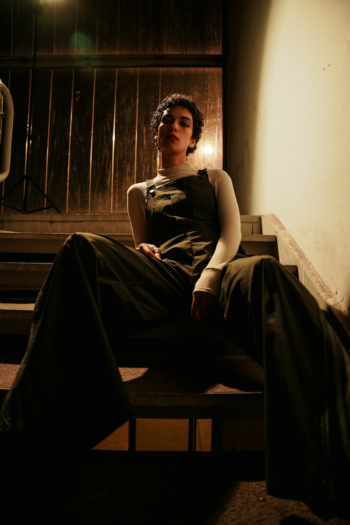 Fashion model posing on stairs in dramatic outfit