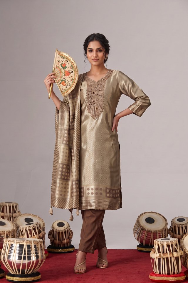Product photo made with CatalogX — a gold silk kurta set with a woven dupatta on a studio set